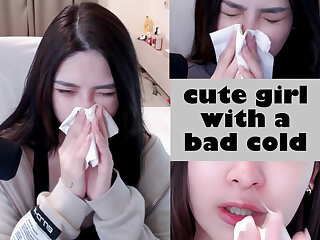 Cute Asian girl blowing her nose during a bad cold - ThisVid.com