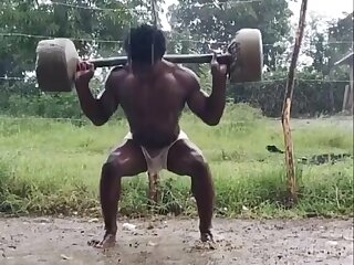 Young Caribbean black male training under the rain - ThisVid.com