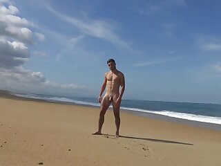 Hot guy gets naked at the beach for photoshoot