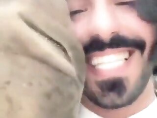 Horny Arab guy making out with a camel in the desert!