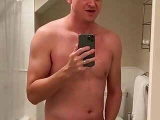 Matthew shoots his cum in the mirror.